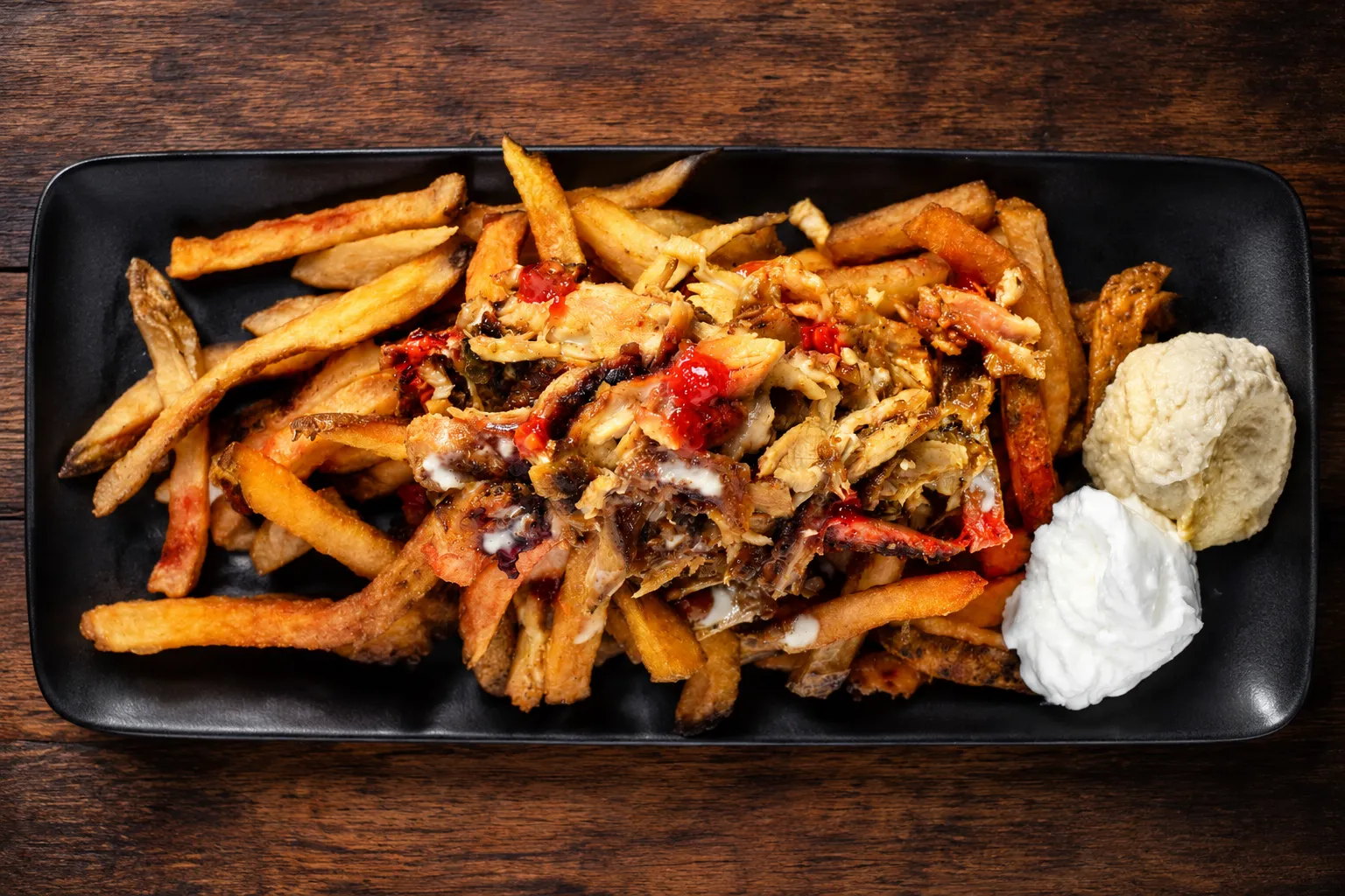 Loaded shawarma fries topped with garlic sauce at Dooly's Shawarma & Falafel, London Ontario
